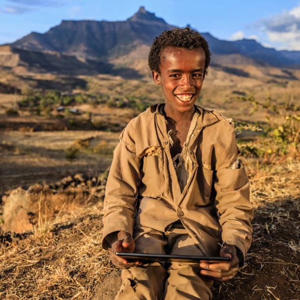 istock Young African boy is using digital tablet, East Africa 1219929221