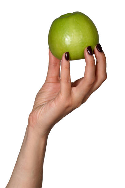 istock Green apple in womans hand. Isolated on white 1219929252