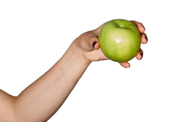 istock Green apple in womans hand. Isolated on white 1219929268