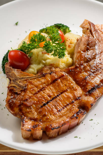 istock Grilled pork chop with mash potato and dressing 1219929342