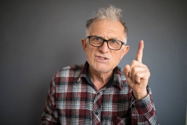 Serious senior man wagging his finger at the camera