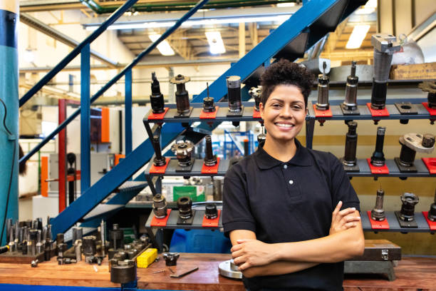 istock Happy female engineer standing in factory 1219929476