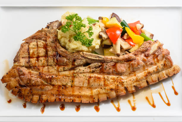istock Grilled pork chop with mash potato and dressing 1219929523