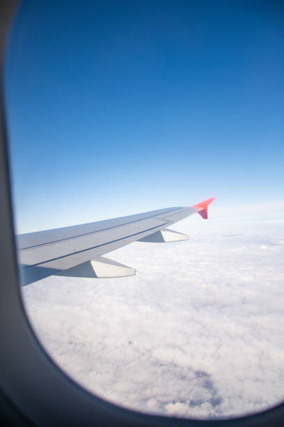 istock Airplane wing and clouds are visible from the porthole 1219929868
