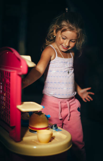 ハッピーリトルガールはおもちゃのキッチンで遊んでいます - tea party little girls teapot child ストックフォトと画像