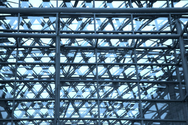 istock Steel framework of industrial or public building. Load-bearing structure under ceiling. Multiple exposure photo on the subject of modern architecture or construction industry. 1219930773
