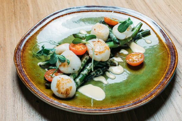 istock grilled fish with vegetables, tomatoes, sauce and herbs on a plate 1219931552