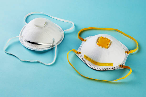 istock Medical face mask on blue background. Protective surgical mask, 1219931654