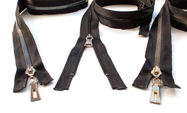 istock two closed and one opened metal  zippers closeup 1219932605