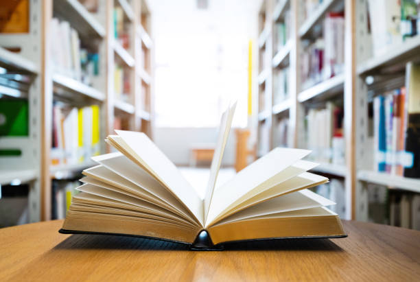 istock Open book on the desk of library 1219932750
