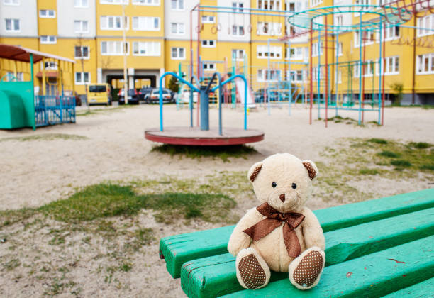 istock forgotten toy teddy bear in the empty quarantined playground 1219933031