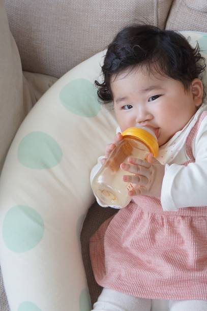 6 months old baby 6 months old baby drinking milk. so cute. 0 11 months photos stock pictures, royalty-free photos & images