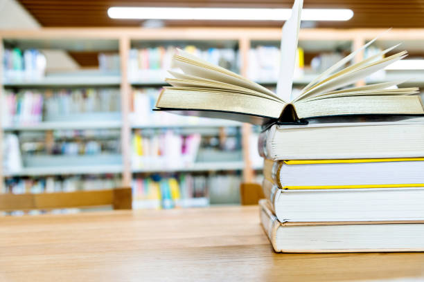 istock Open book on the desk of library 1219933481