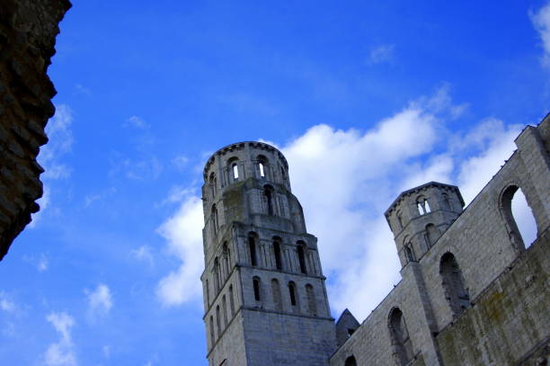 Architectural detail from historic city Avallon, France.In the background, The Tour de l'Horloge is the clock tower of the medieval walled city of Avallon. The massive building from the 14th century served as an important city gate and seat of the city's night watch.