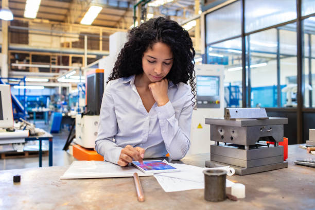 istock Woman engineer working on her digital tablet in factory 1219934342