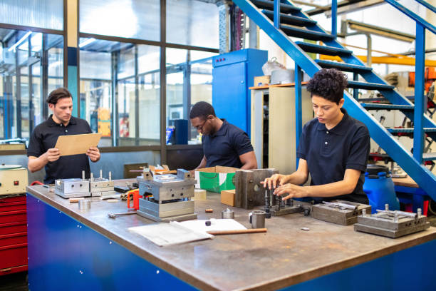 istock Group of workers working in factory tool room 1219934807