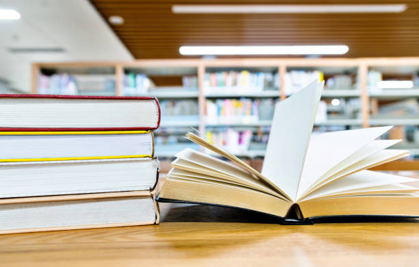 istock Open book on the desk of library 1219935082
