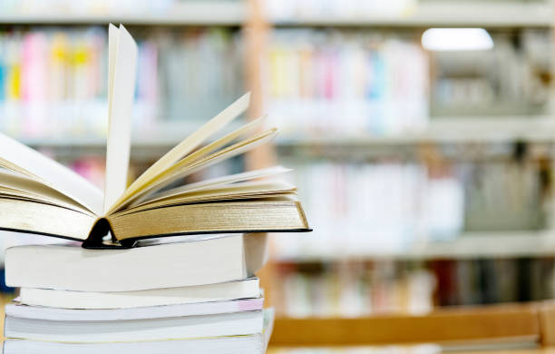 istock Open book on the desk of library 1219935087