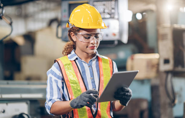 istock professional women  engineer checklist automated CNC on Tablet in factory 1219935713