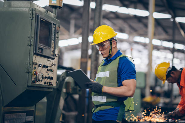 istock technician engineer checking process on tablet to machinery in factory 1219936379