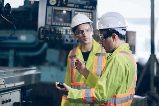 istock Worker and mentor discussion in Factory CNC machine operator 1219936394