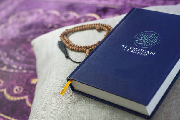 istock Al-Quran and beads with natural light at home 1219936632