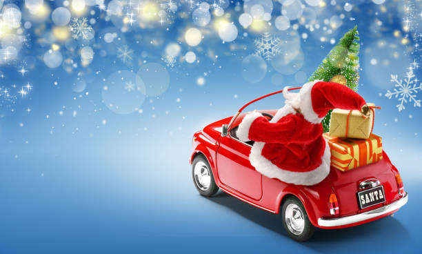 istock Santa Claus driving red car with gift boxes and Christmas tree on blue background with bokeh lights 1219937270