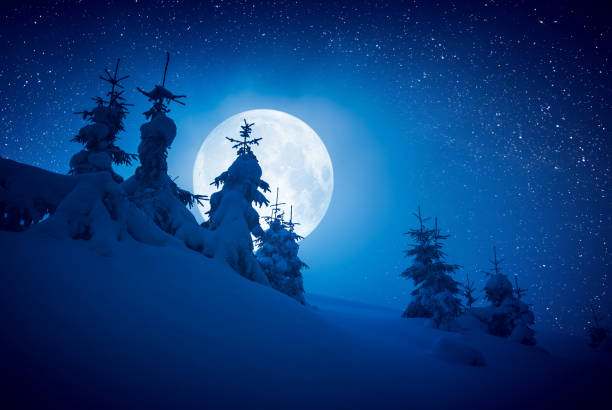 istock Full moon rising above the winter valley covered with fresh snow 1219937511