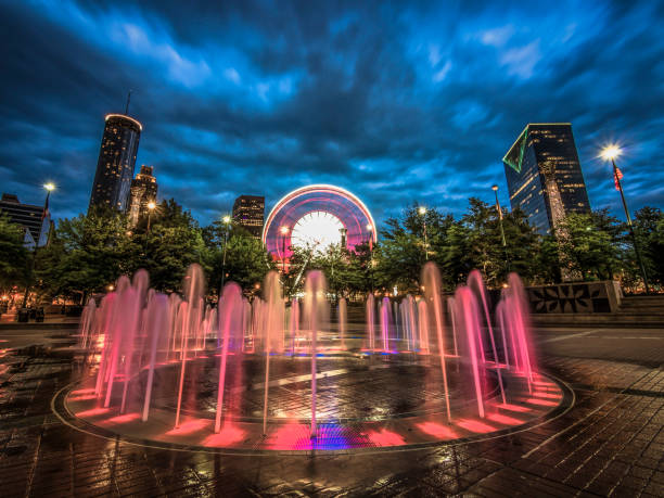 Centennial Olympic Park Fountains in Atlanta Long exposure of the water fountains in Centennial Olympic Park in Downtown Atlanta, Georgia with the city skyline and Ferris wheel in the background atlanta georgia stock pictures, royalty-free photos & images
