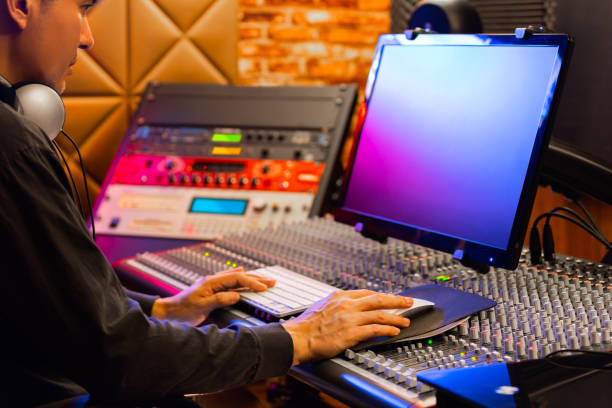 istock asian male producer working on computer in broadcasting, editing studio 1219939433