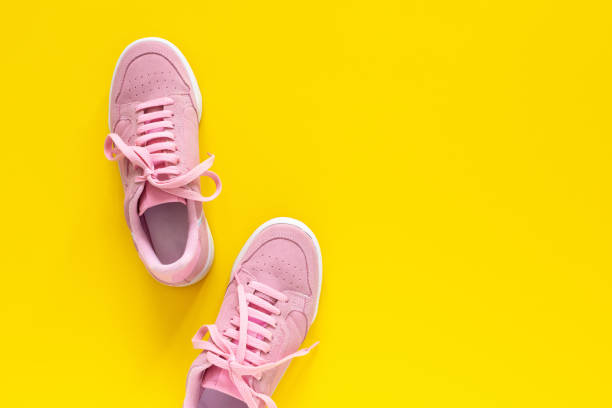 istock Pink sneakers isolated on a yellow background 1219940291