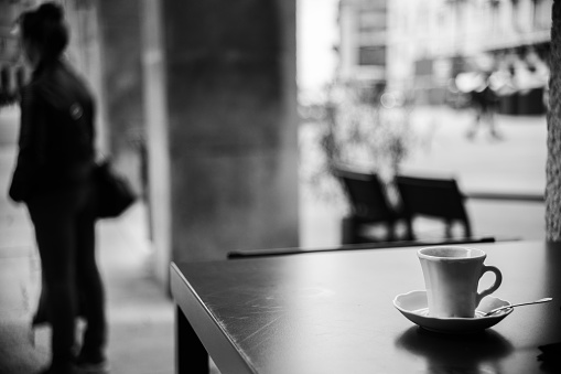 Street photo of a coffee cup on a table (Trieste, FVG, Italy).