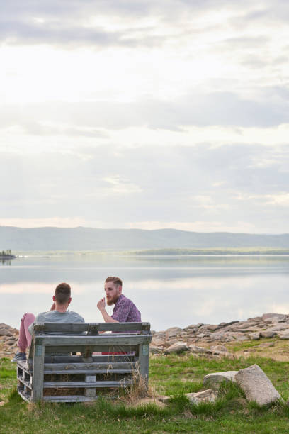 istock Friends Resting By Lake 1219940811