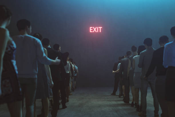 istock Tired people waiting in front of Exit sign 1219940831