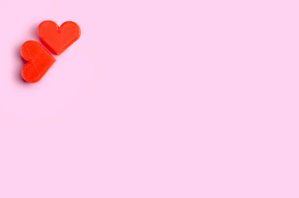 istock Two heart on pink paper background love concept copy space 1219940944