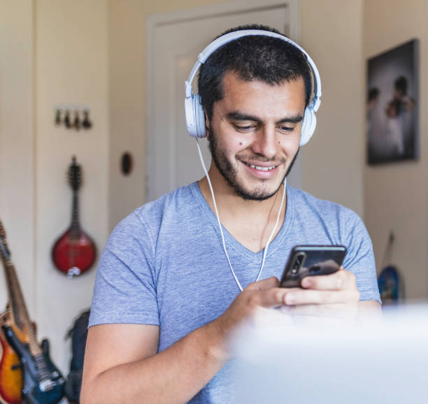 istock Men listening music with technology 1219941031