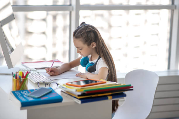 istock Long-haired girl in white tshirt looking busy 1219941097