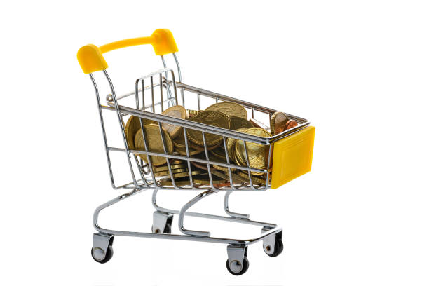 istock Small coins are in the shopping cart. Selective focus. 1219941351