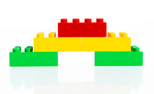 Stairs made of plastic blocks on white background.