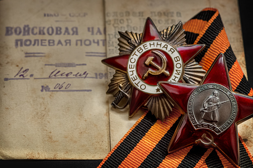 Order of the Patriotic War of the second degree and Red Star order  on George Ribbon and old letter background for the great day of Victory