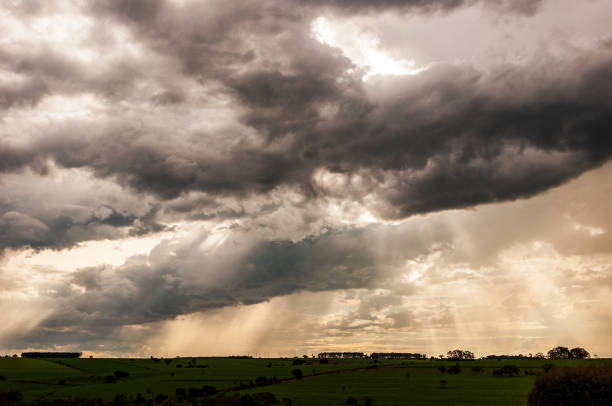 istock Rural field scene with storm clouds in the sky and landscape 1219943128