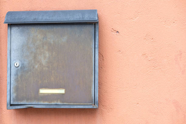 istock Old metal mailbox on the cement wall. 1219943548