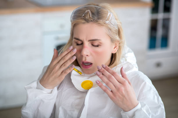 istock Blonde utility worker in workwear suffering from allergy 1219945079