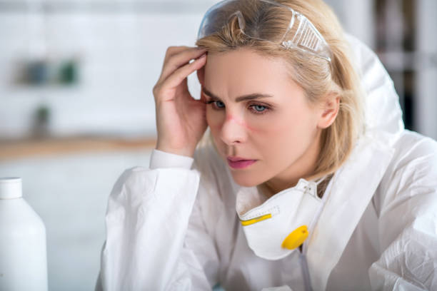 istock Blonde woman in white workwear looking tired 1219945404
