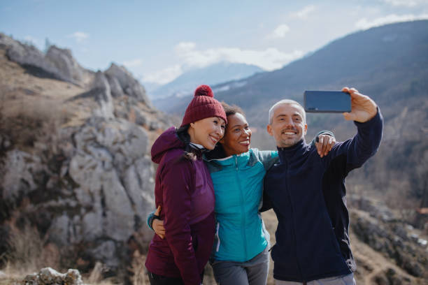 istock Group of people taking selfie on mountain climbing trip 1219946688