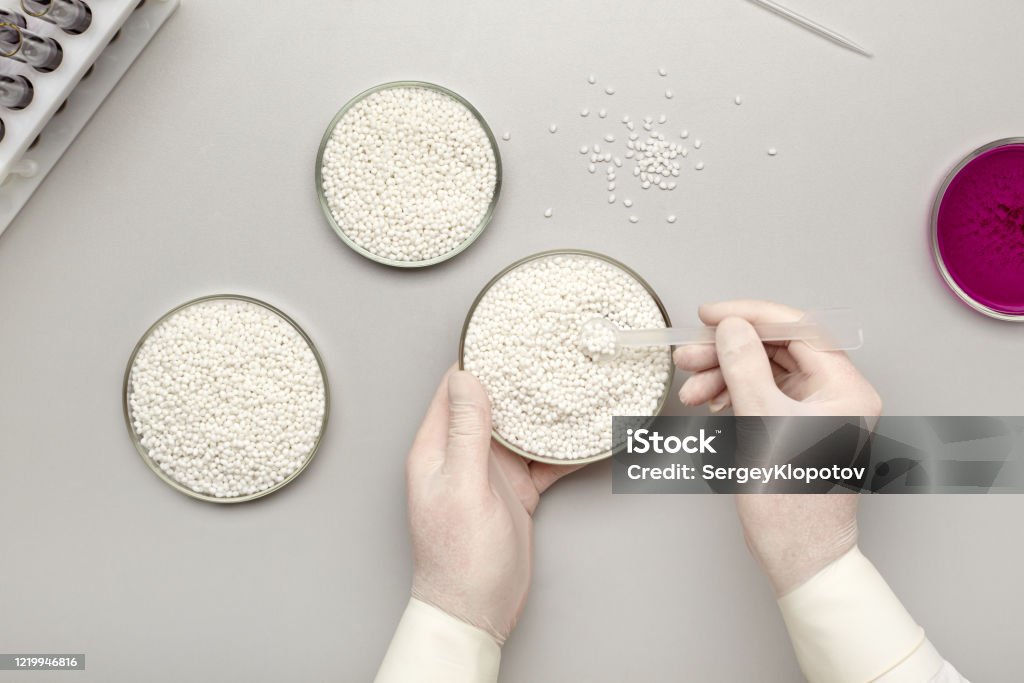 Polymer Sample Lab Laboratory Assistant Taking A Sample From A New Batch Of White Plastic ...