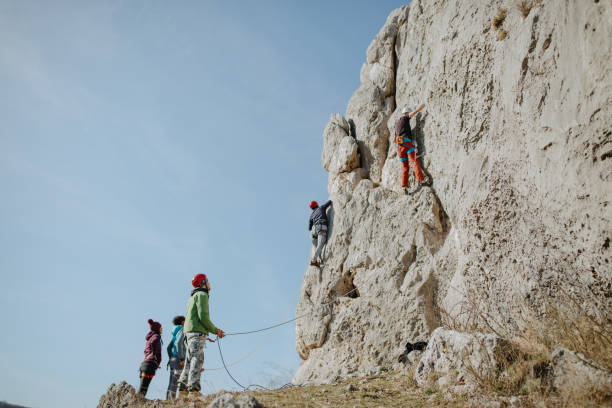 istock Two men climbing while belayers control the rope that is attached to the climbers 1219947114