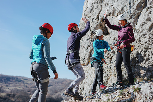 Climbers giving high fives after successfully finishing climb