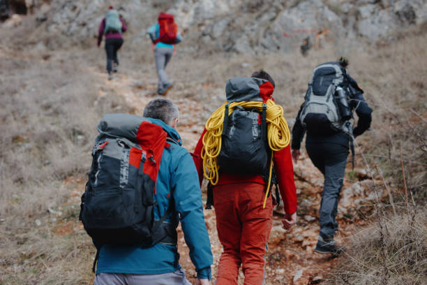 istock Climbing learners following their climbing instructor in rough terrain 1219947388