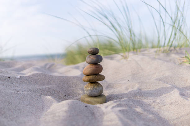 stone cairns at the beach, baltic sea stone cairns in the sand, baltic sea cairn stock pictures, royalty-free photos & images